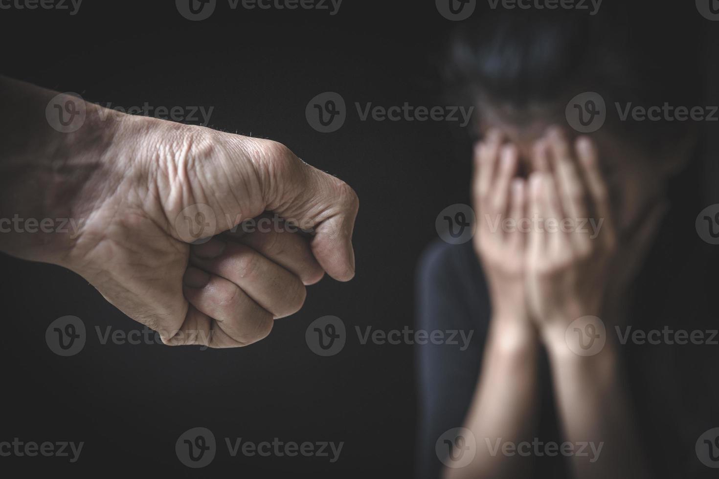 A man's hand will hurt a woman. Domestic violence and harassment of women. International Women's Day. photo