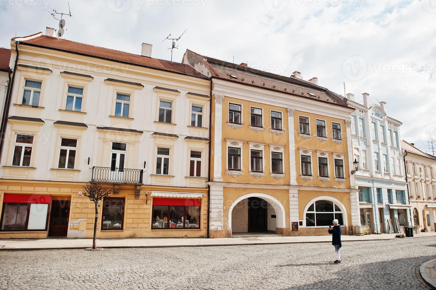 Boy making photo by phone in historical Mikulov, Moravia, Czech Republic. Old European town.