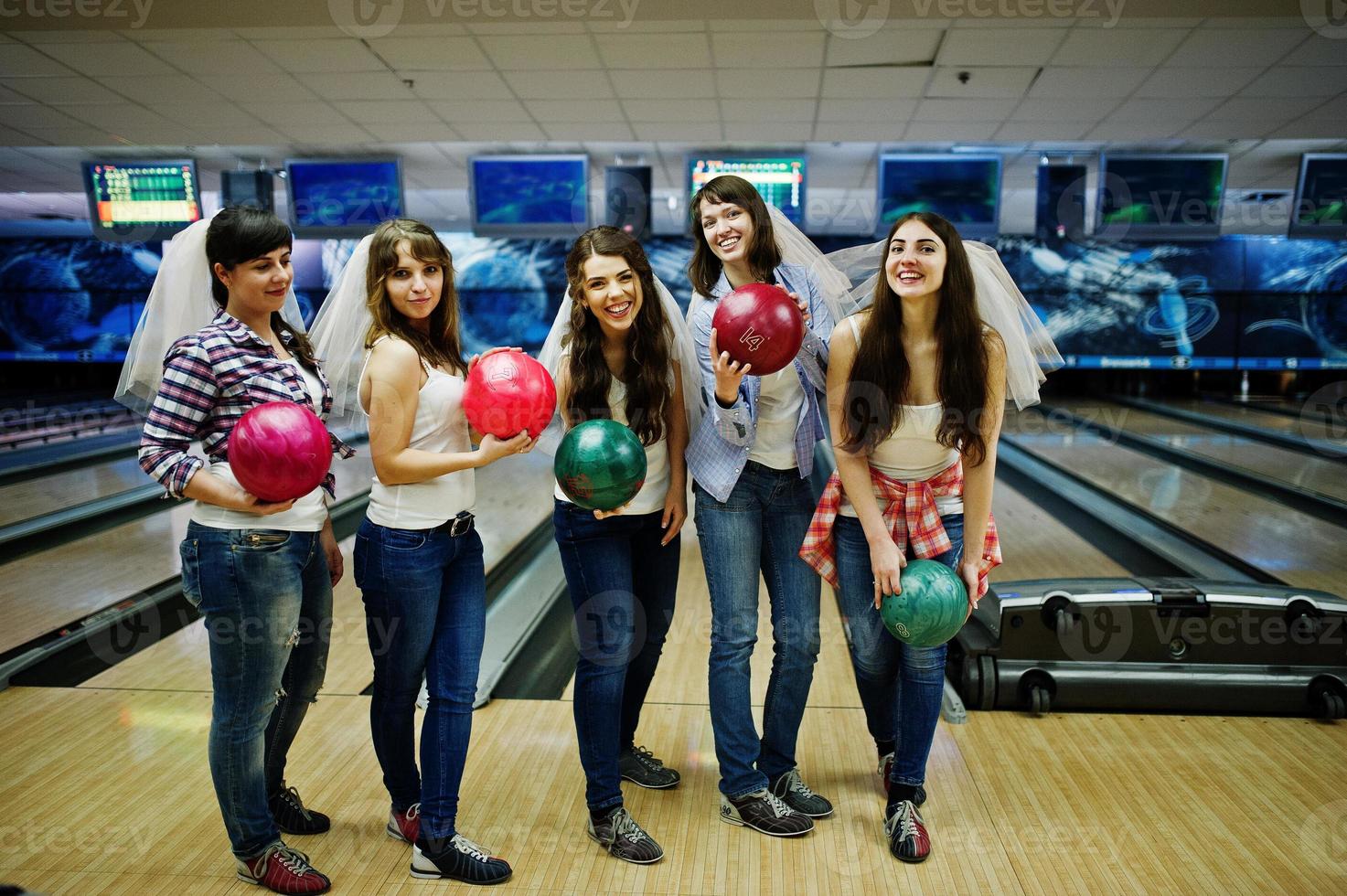 Group of six girls wit bowling balls at hen party on bowling club. photo