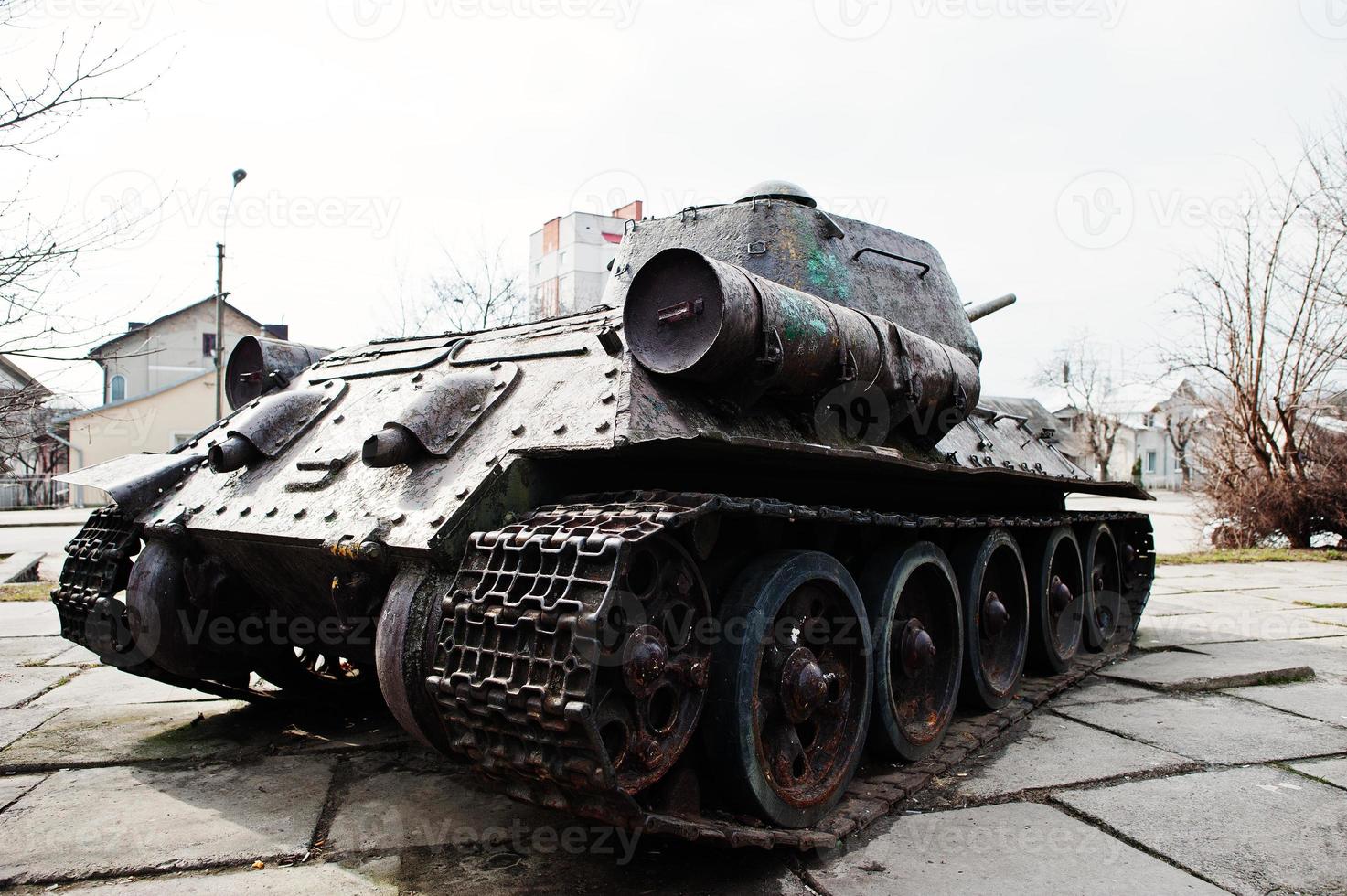 Old vintage military tank in the city pedestal. photo