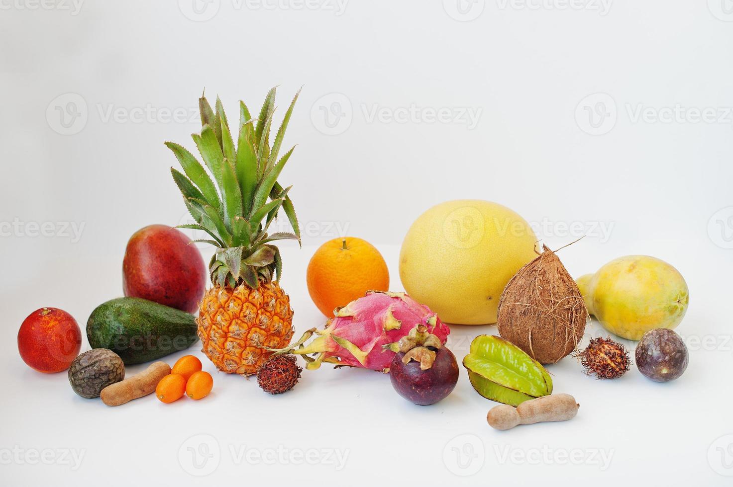 Exotic fruits isolated on white background. Healthy eating dieting food. Pitahaya, carambola, papaya, baby pineapple, mango, passion fruit, tamarind and other. photo