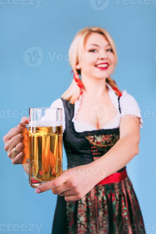portrait of beautiful blonde cheerful smiling woman in bavarian traditional national dress photo