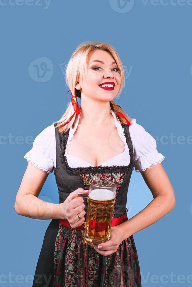 portrait of beautiful blonde cheerful smiling woman in bavarian traditional national dress photo