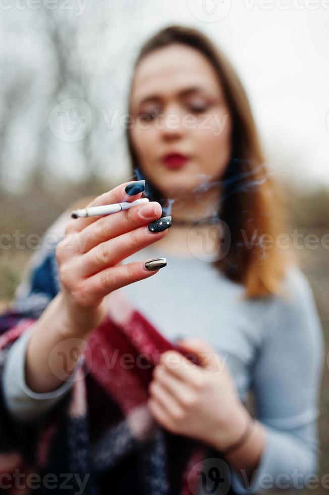 Hand of girl with cigarette. Stop smoking social problem. photo