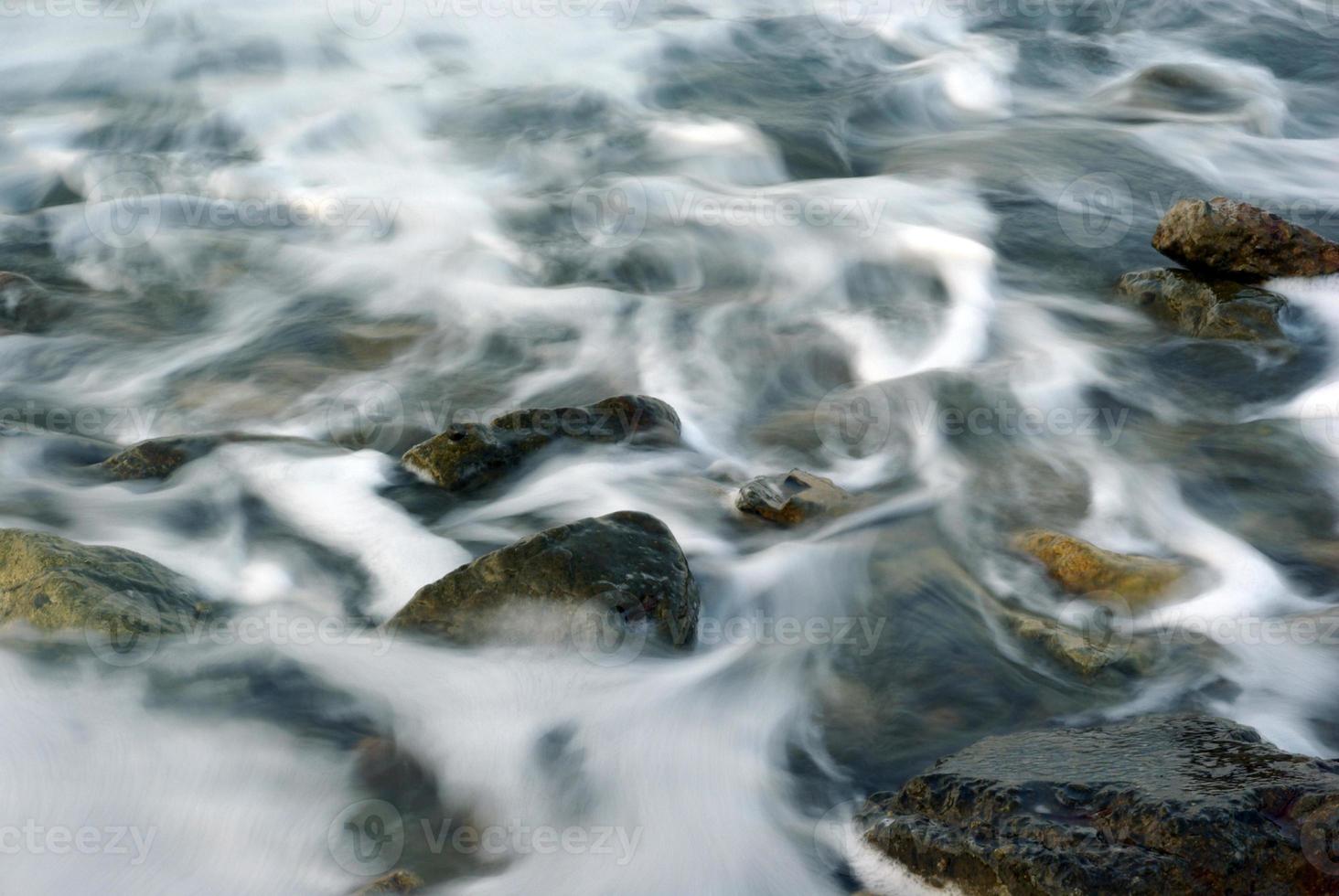 Turbulence sea water and rock at Coastline photo