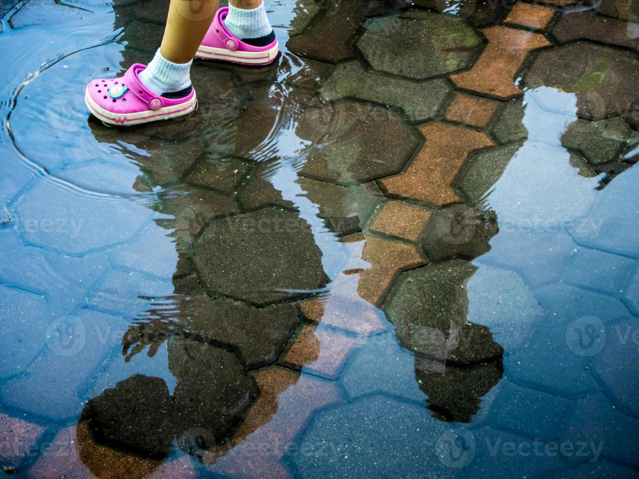 Children walk through swampy areas on floor photo