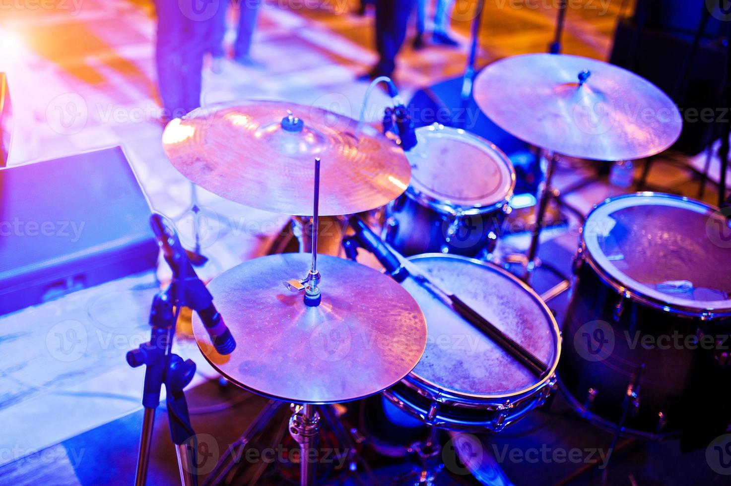 Drum set at stage on violet lights. photo