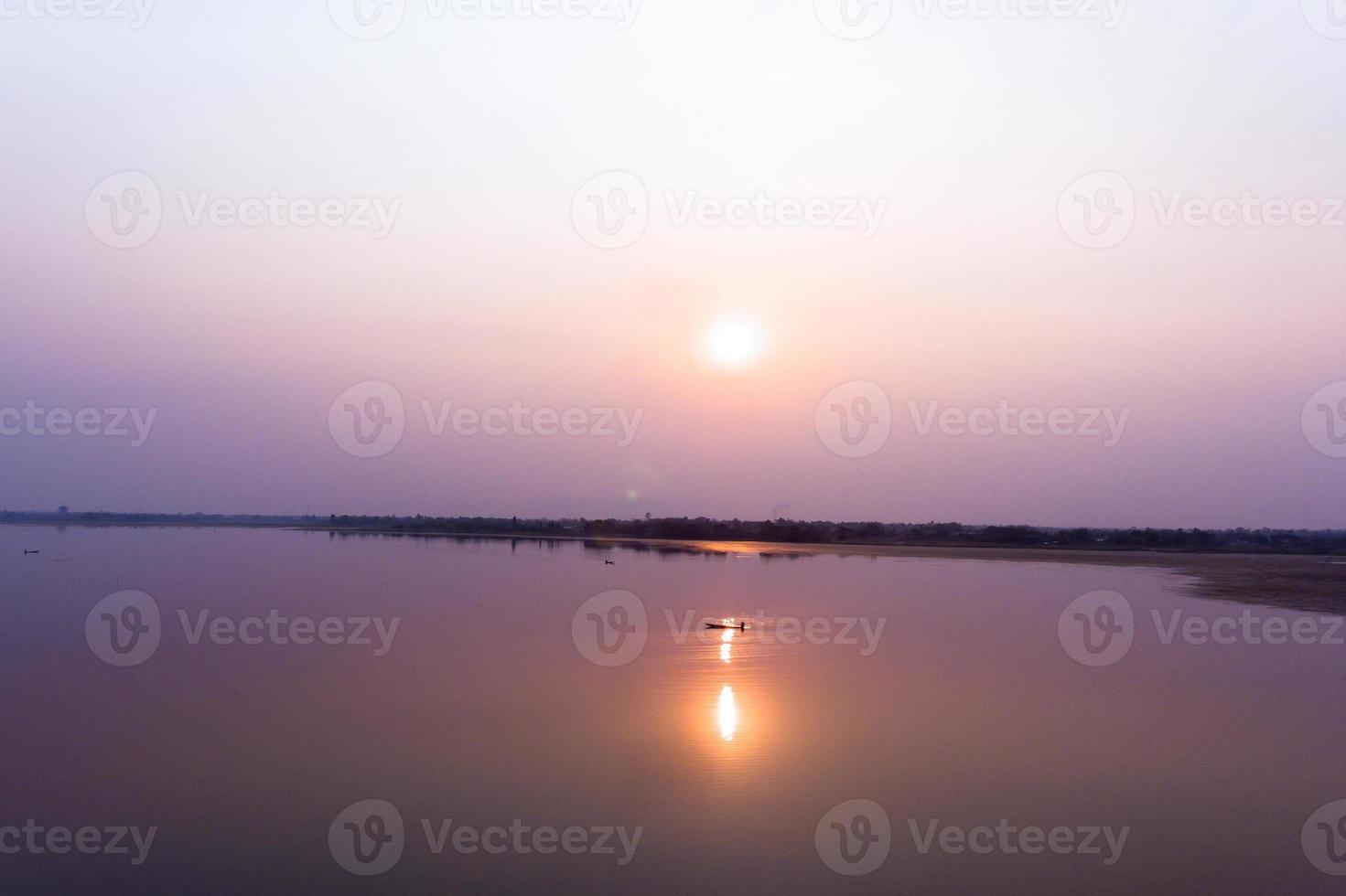 small fishing boat in larg dam photo