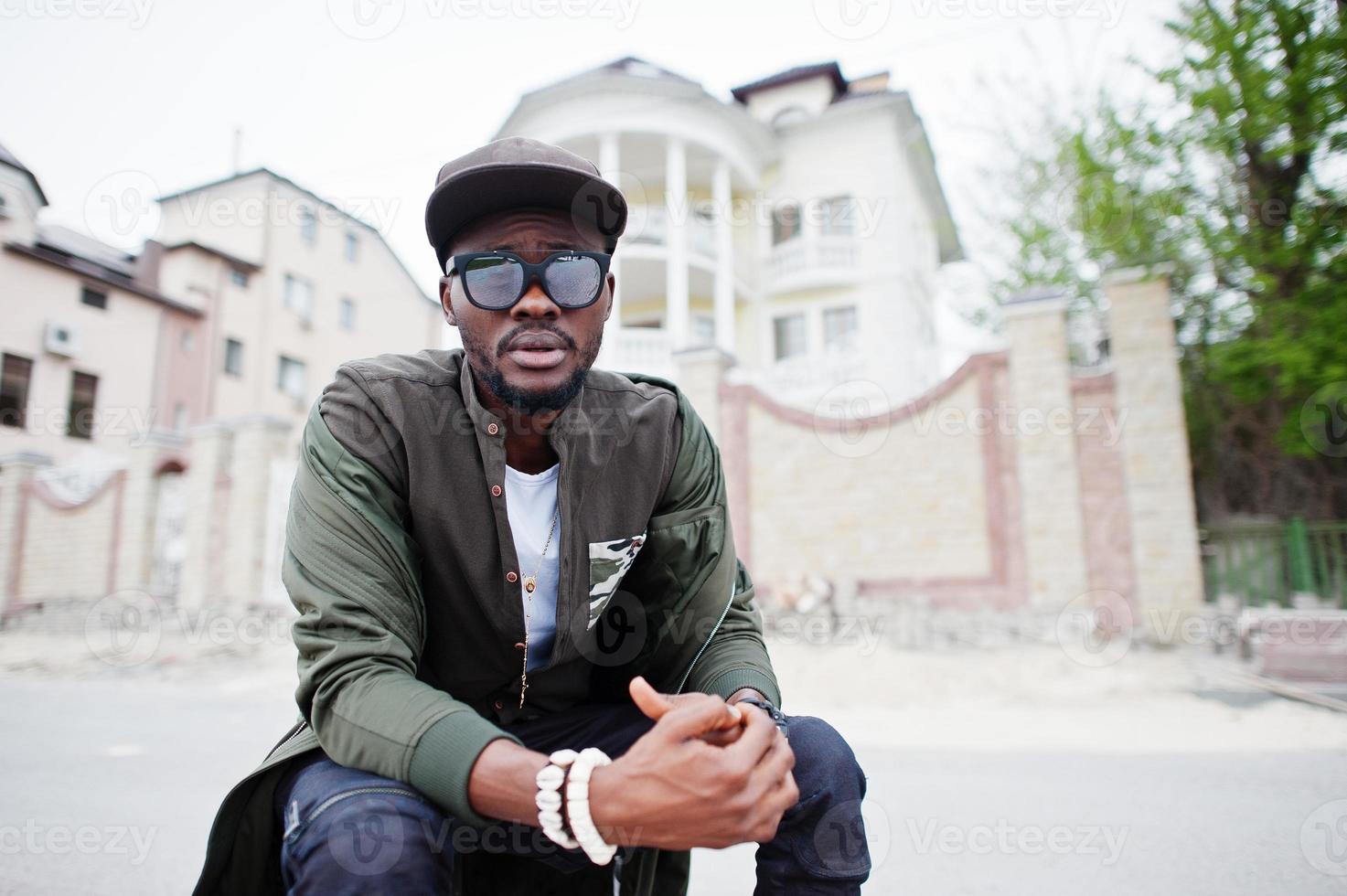 Close up portrait of stylish african american man wear on sunglasses and cap outdoor. Street fashion black man. photo