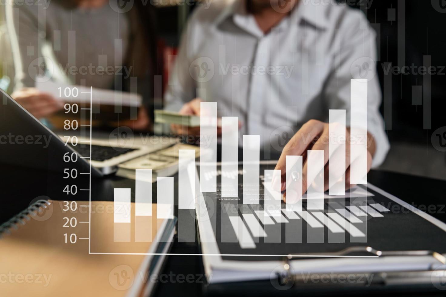 Business documents on office table with smart phone and calculator digital tablet and graph photo