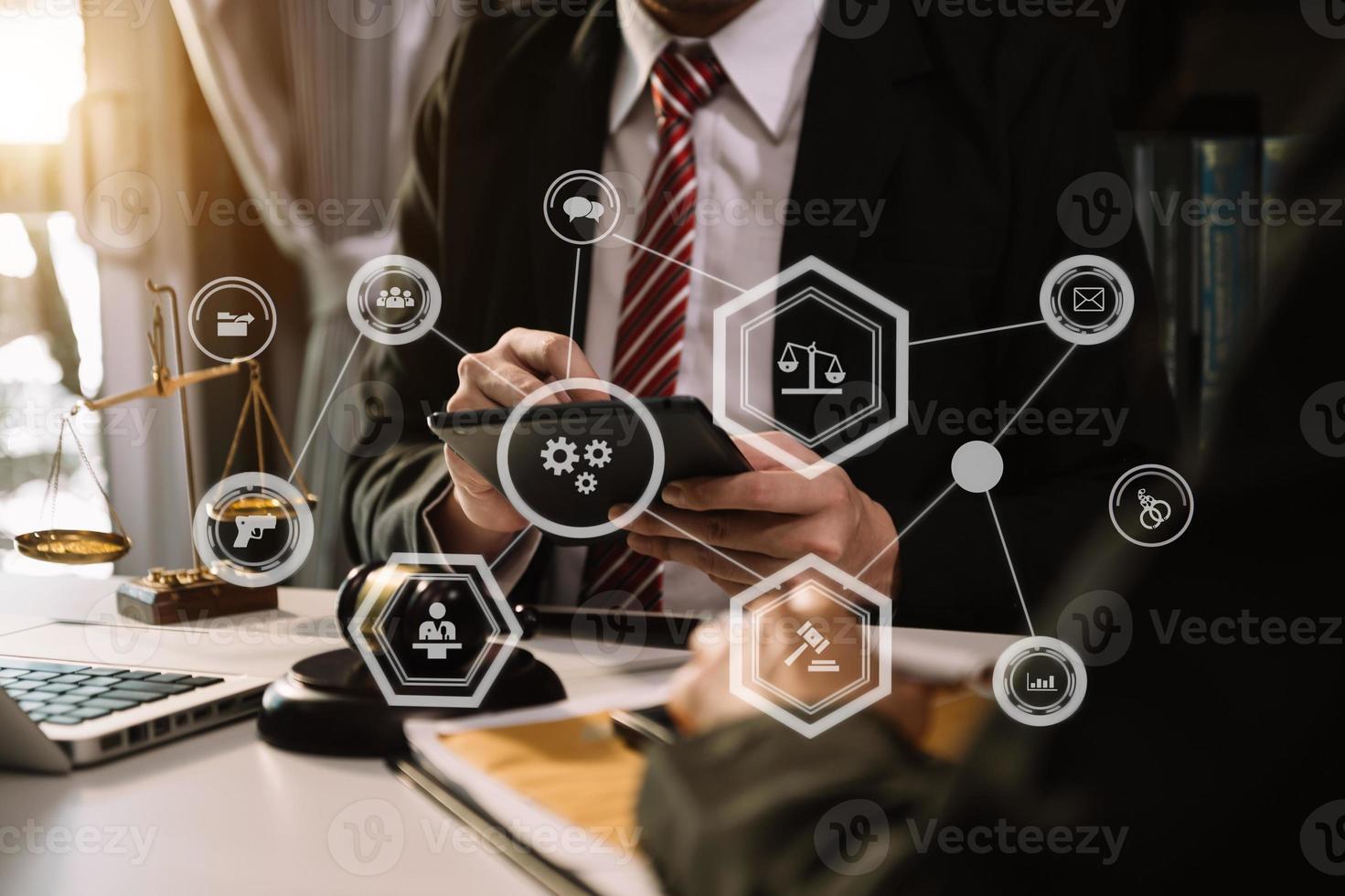 justice and law concept.Male judge in a courtroom  the gavel, working with smart phone and laptop and digital tablet computer on wood table with VR icon photo