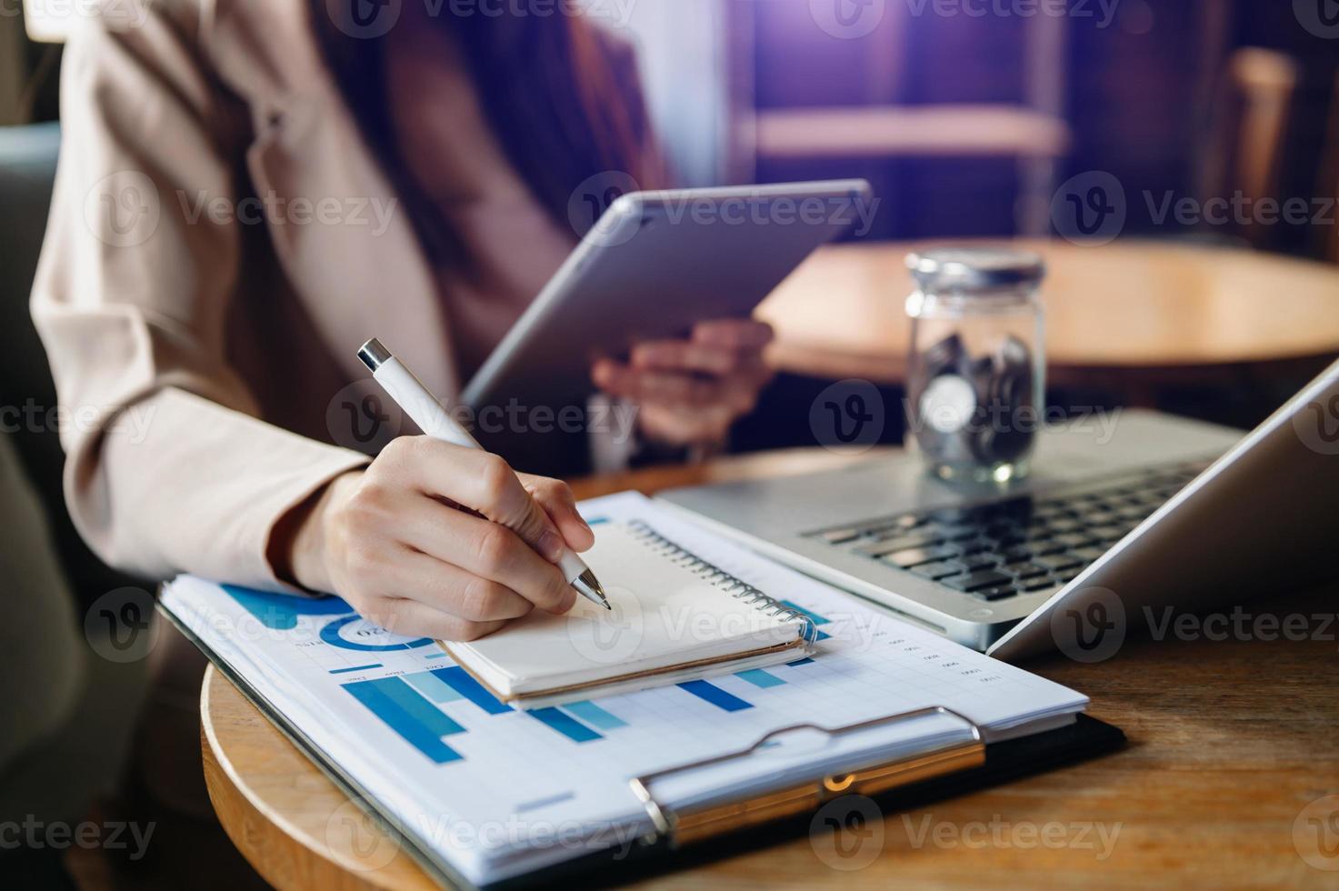 business documents on office desk with laptop and smart phone and graph business diagram and man working photo