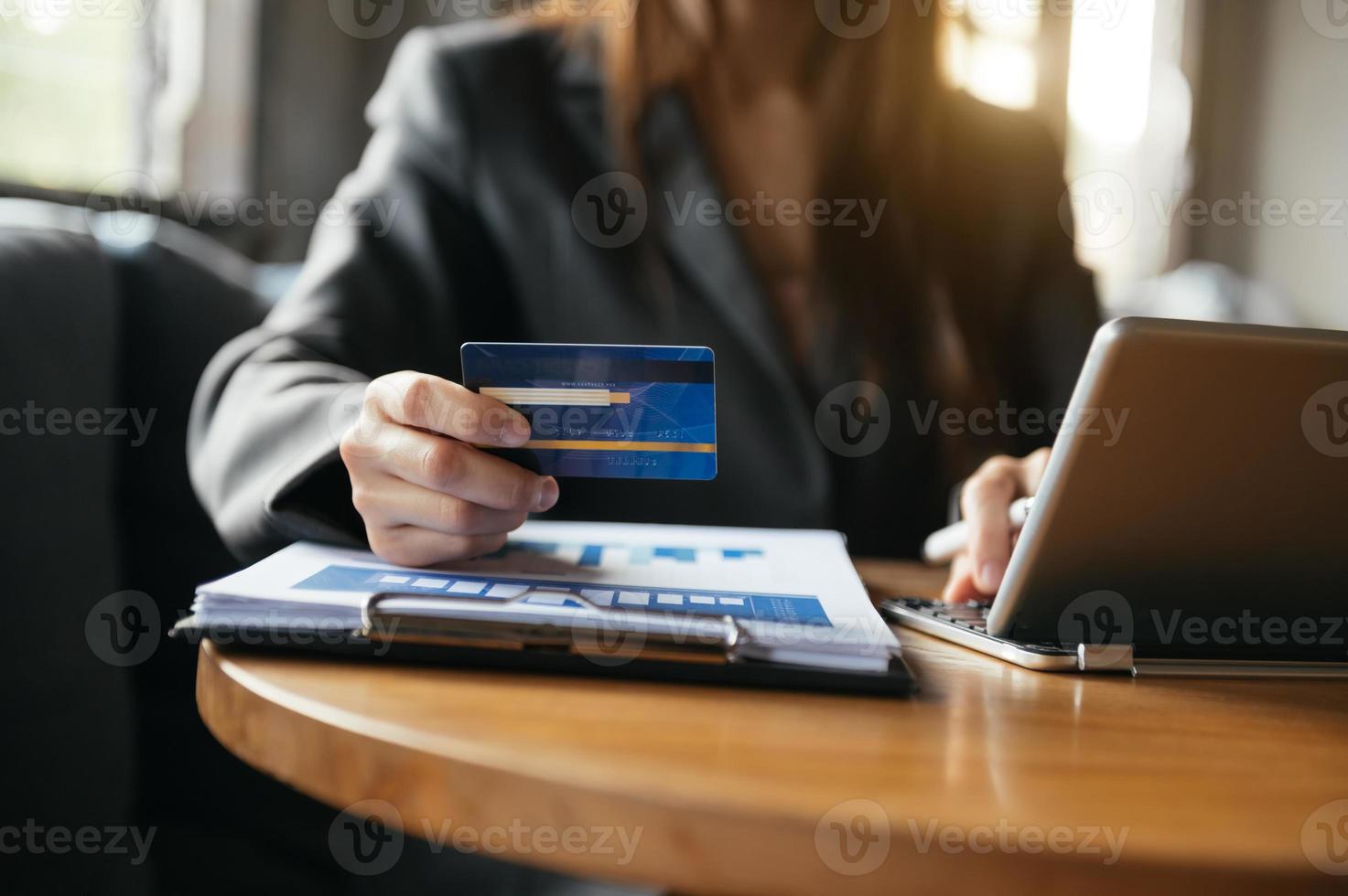 Hands using smartphone and holding credit card with digital layer effect photo