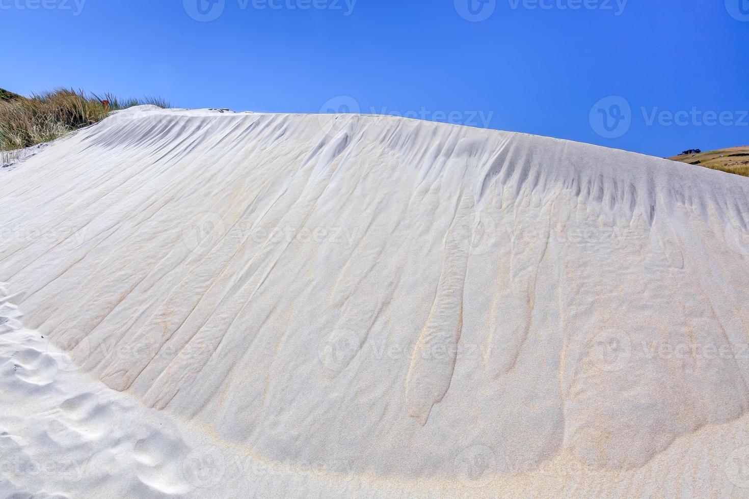 A spectacular sand dune at Sandfly Bay photo