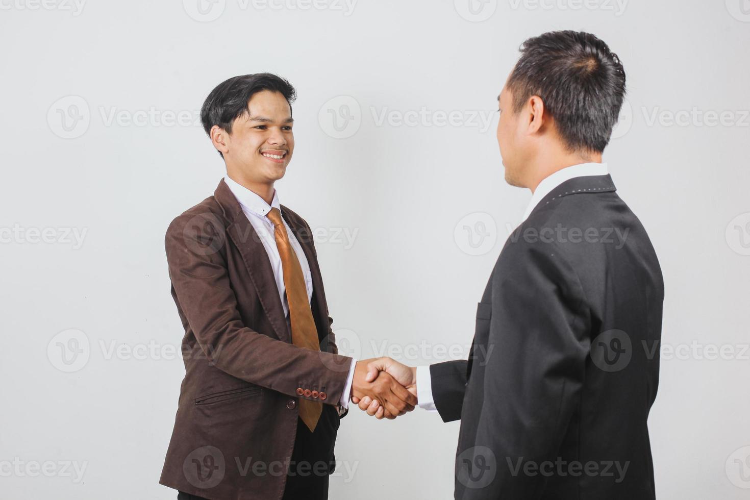 Young handsome Asian businessman make a handshake with partner photo