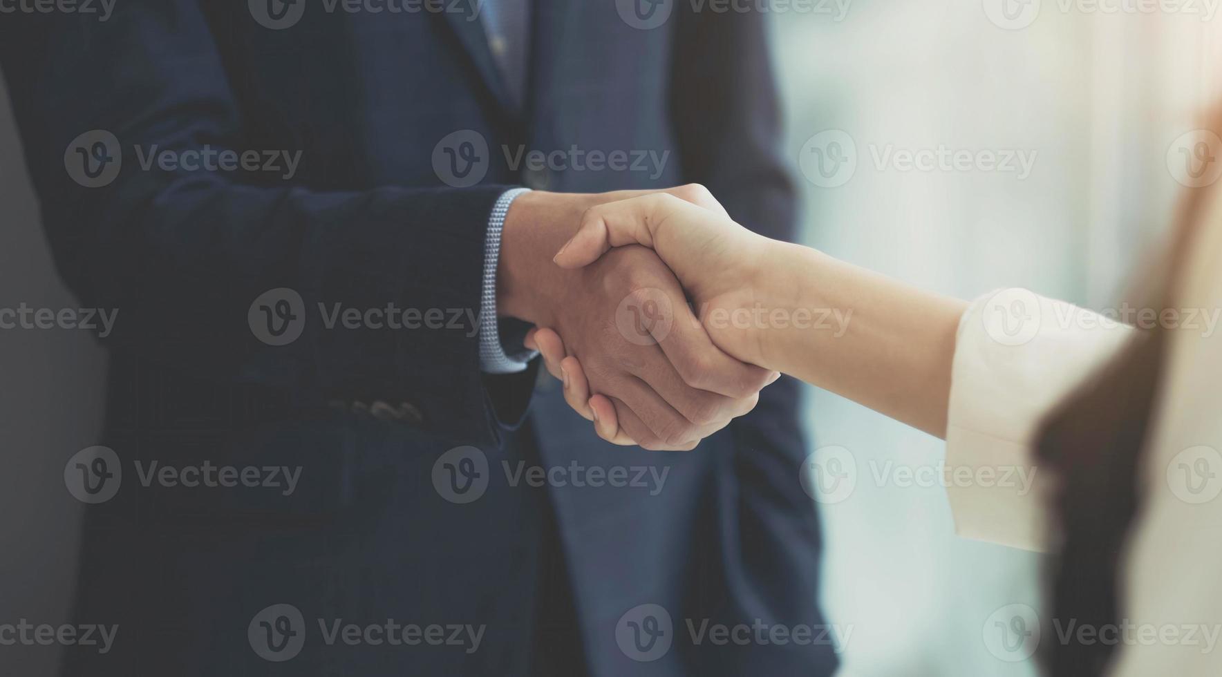 Close up of Business people shaking hands, finishing up meeting, business etiquette, congratulation, merger and acquisition concept photo