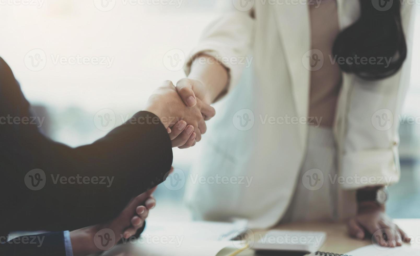 Close up of Business people shaking hands, finishing up meeting, business etiquette, congratulation, merger and acquisition concept photo