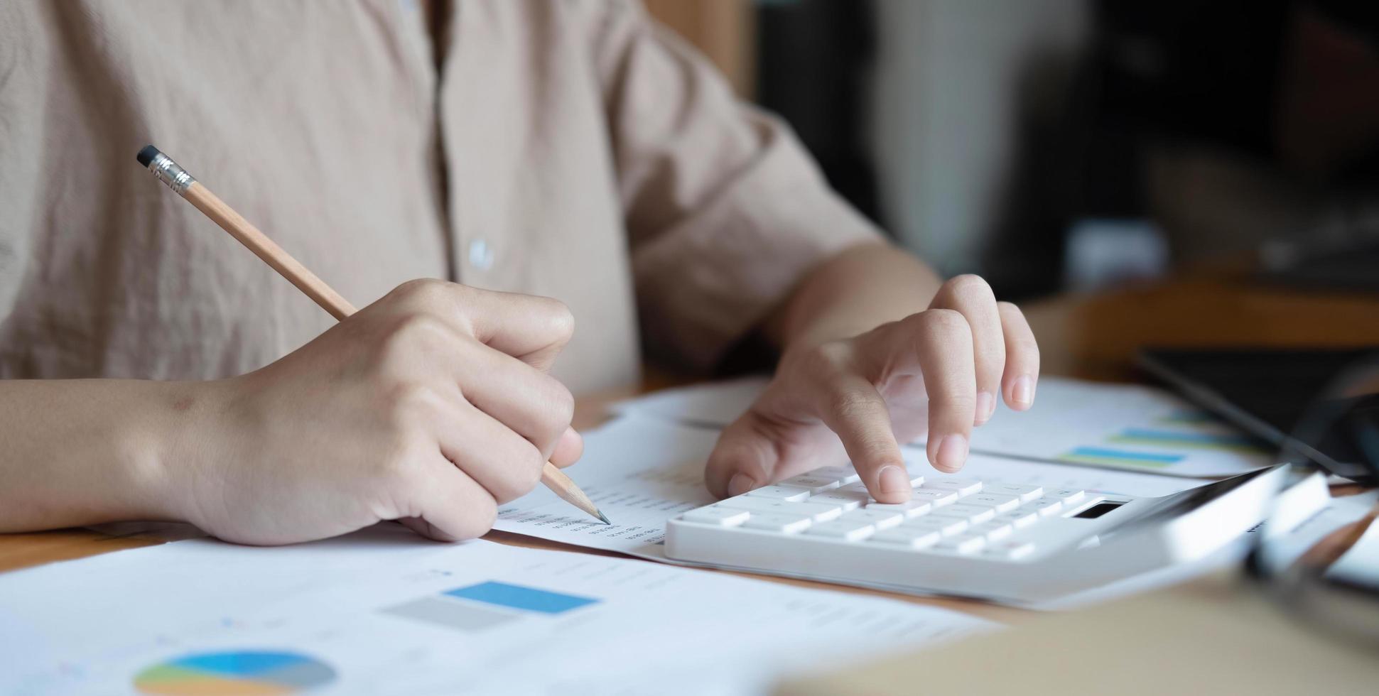 Close up woman financial inspector and secretary making report calculating balance. Internal Revenue Service checking document. photo