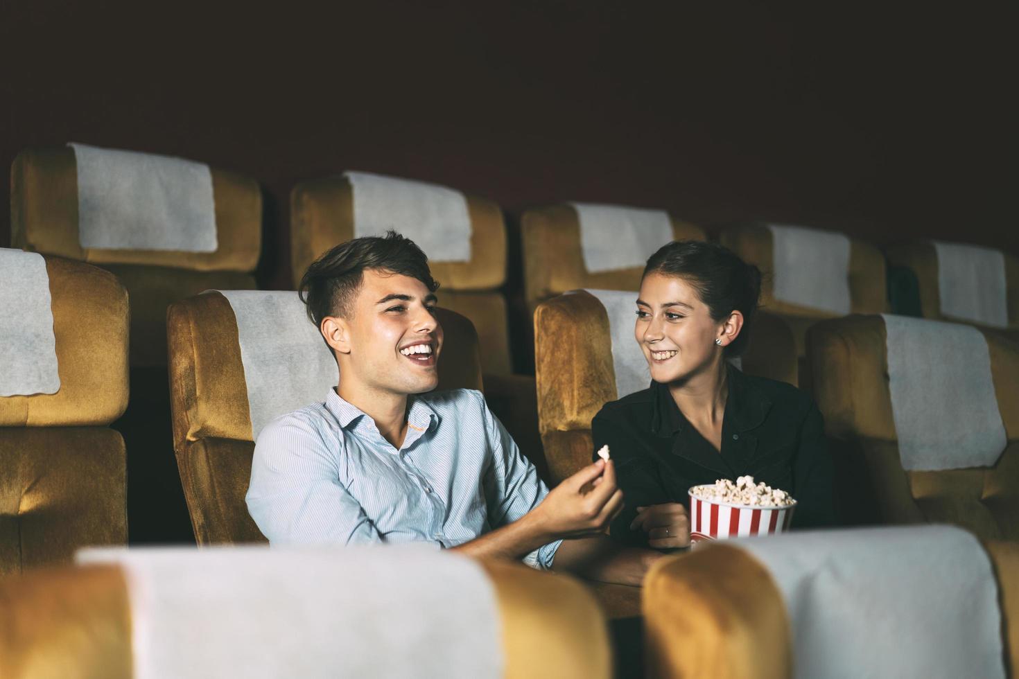 Young adult caucasian people watching movie in theater. photo