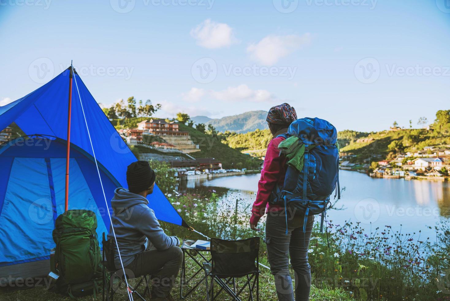 Couple Enjoying Camping Holiday In Countryside.Camp in the mountains near of the lake. photo