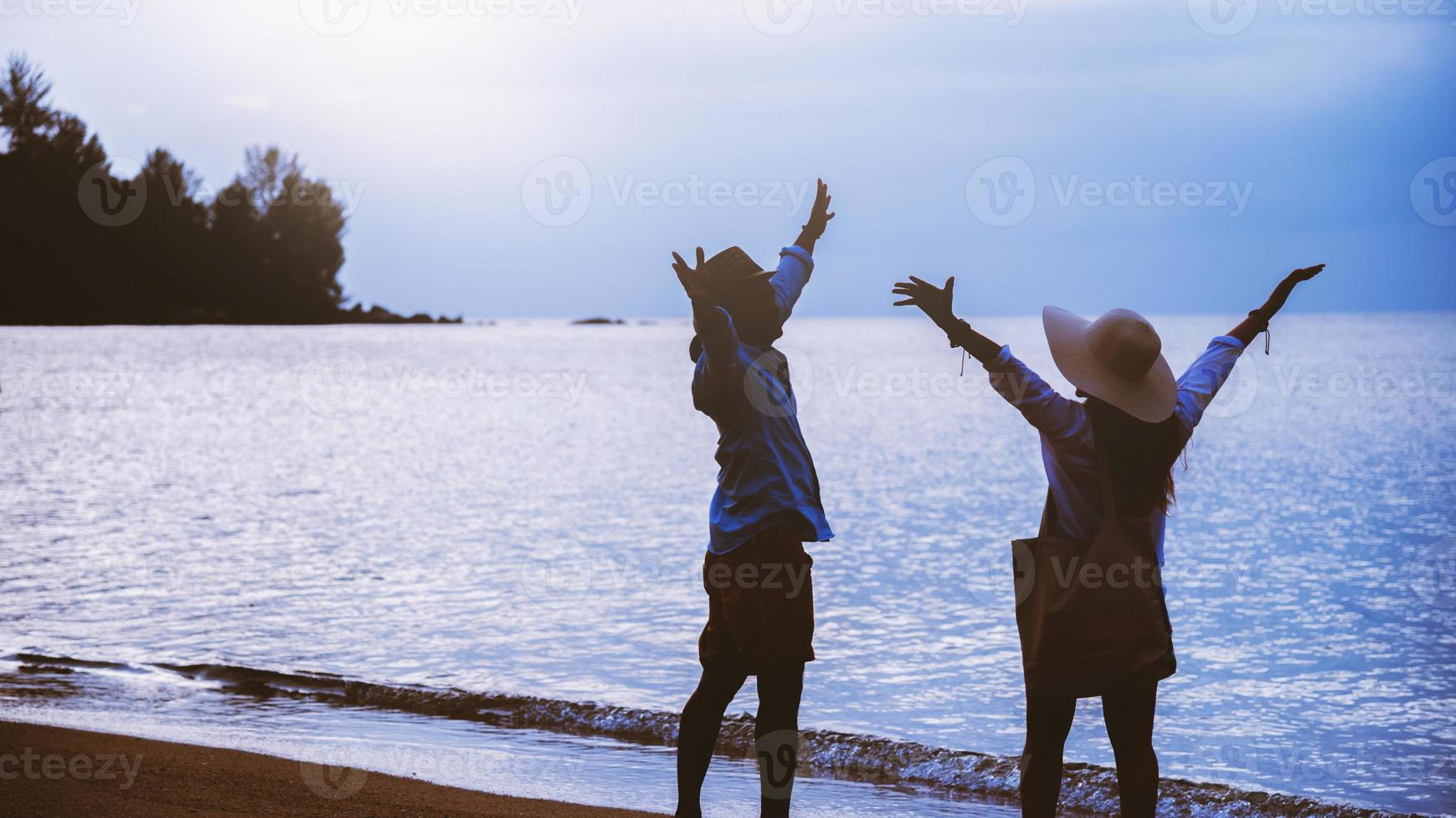 Asian lover couple woman and man travel nature. Travel relax. Walking on the beach. In the summer photo