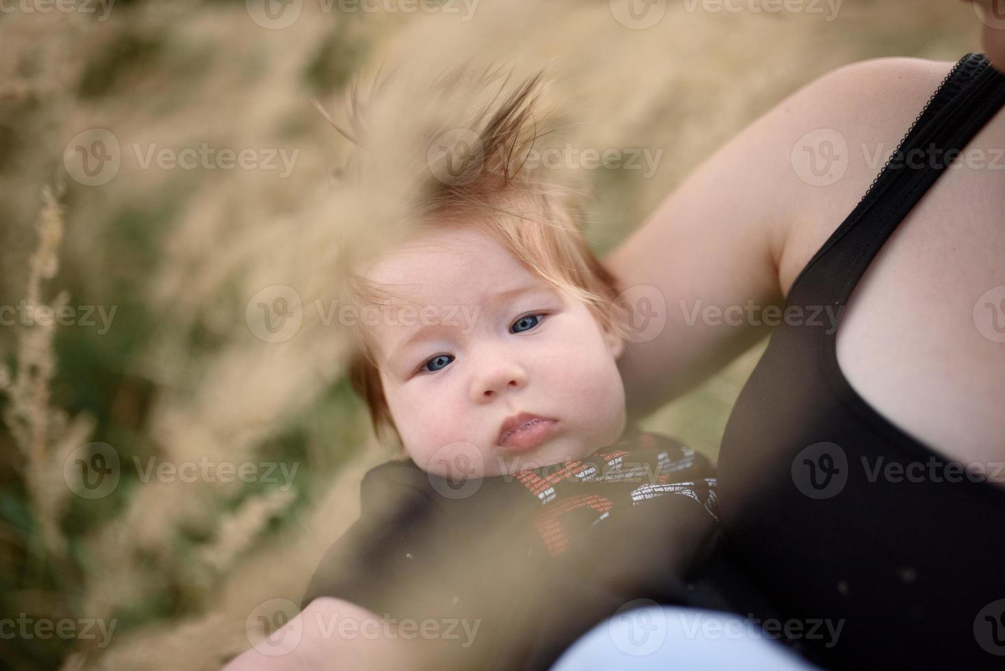 Young mother hugging cute baby at home photo