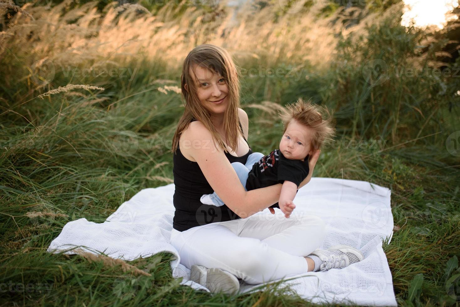 Mom and baby cuddle on a plaid photo