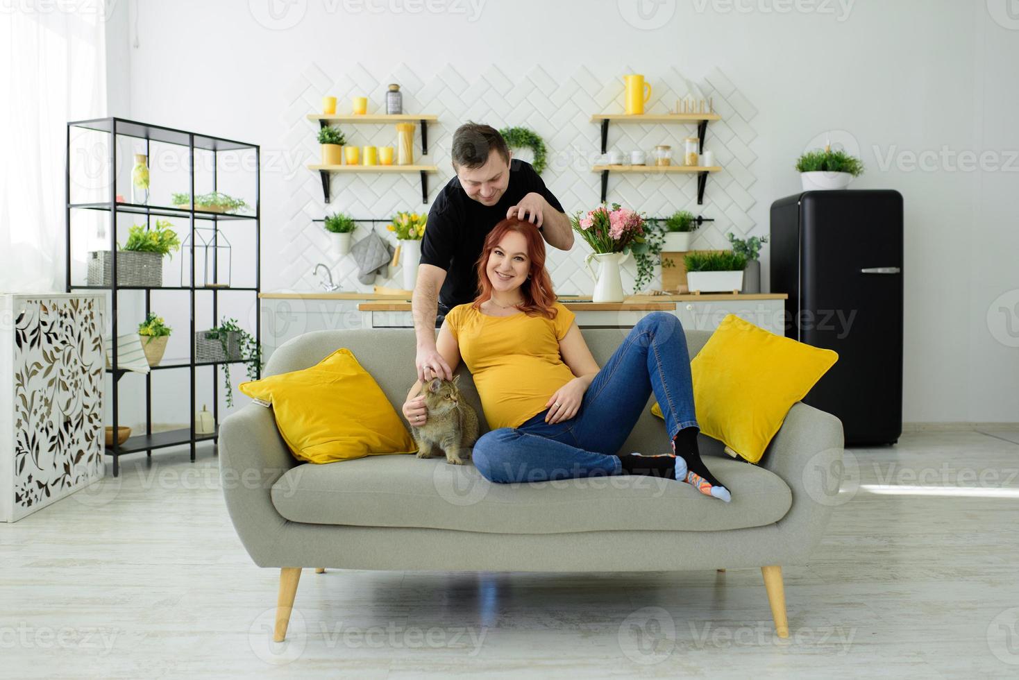 Pregnant couple have fun at home. Self isolation. photo