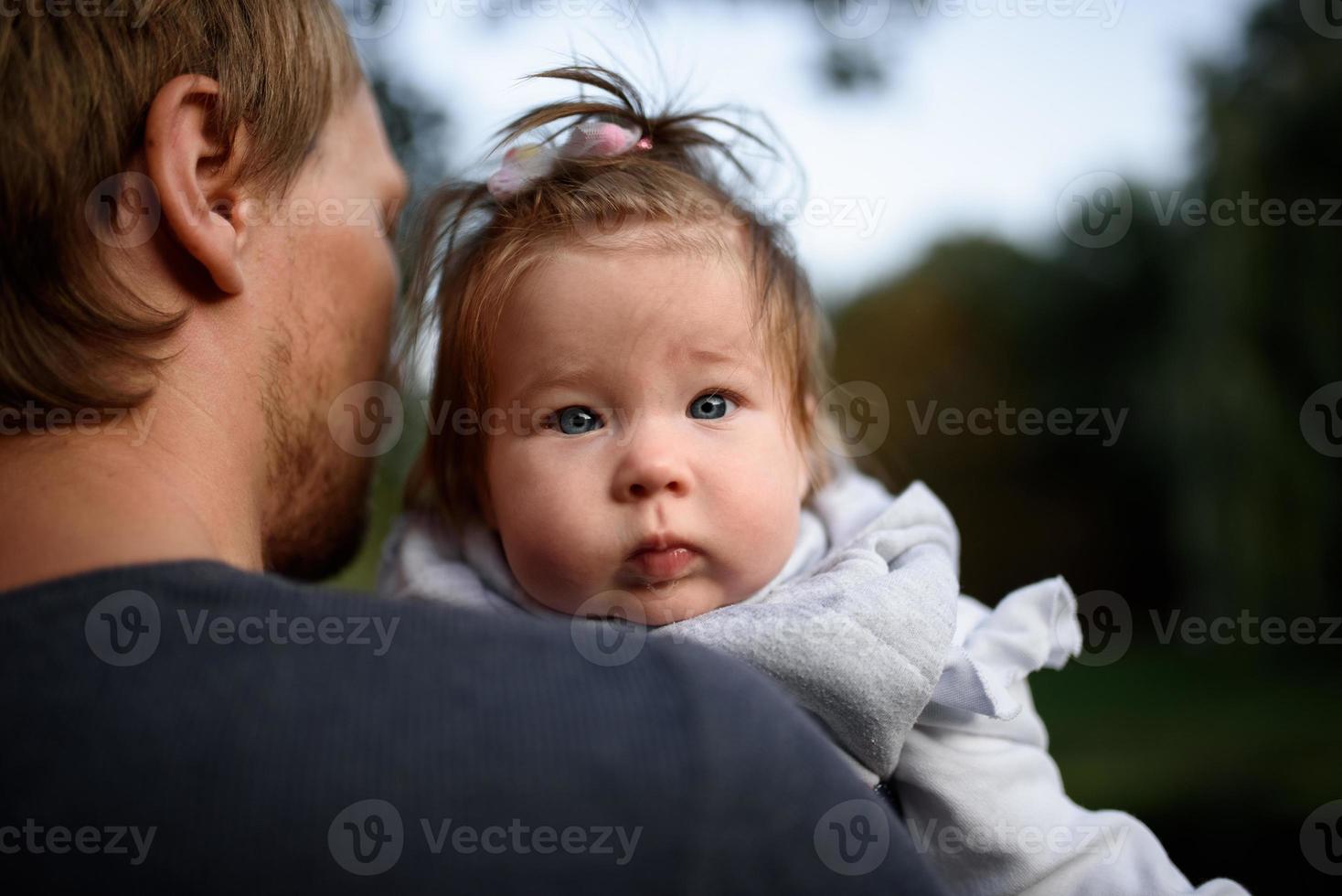 Young father having fun with his little daughter in park photo