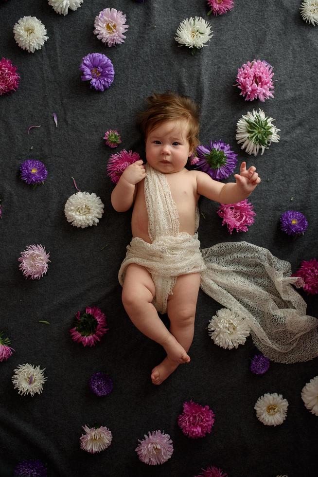 Portrait of little baby girl in white vintage home with flowers photo
