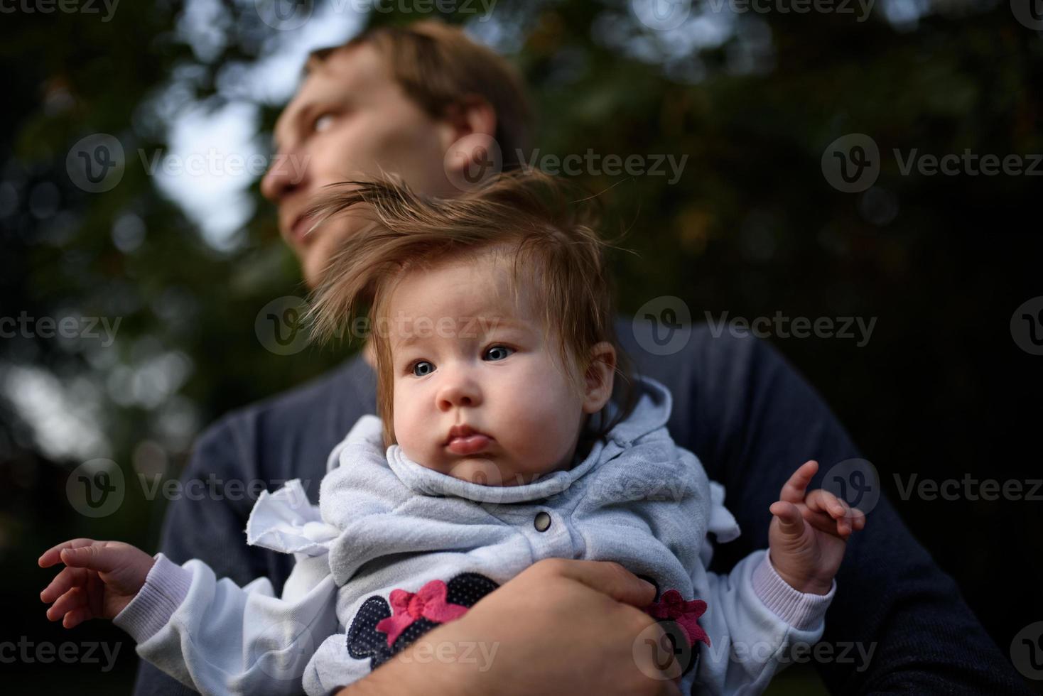 Young father having fun with his little daughter in park photo