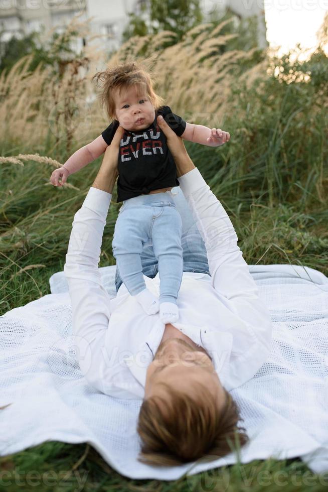 Father and daughter play on a plaid photo