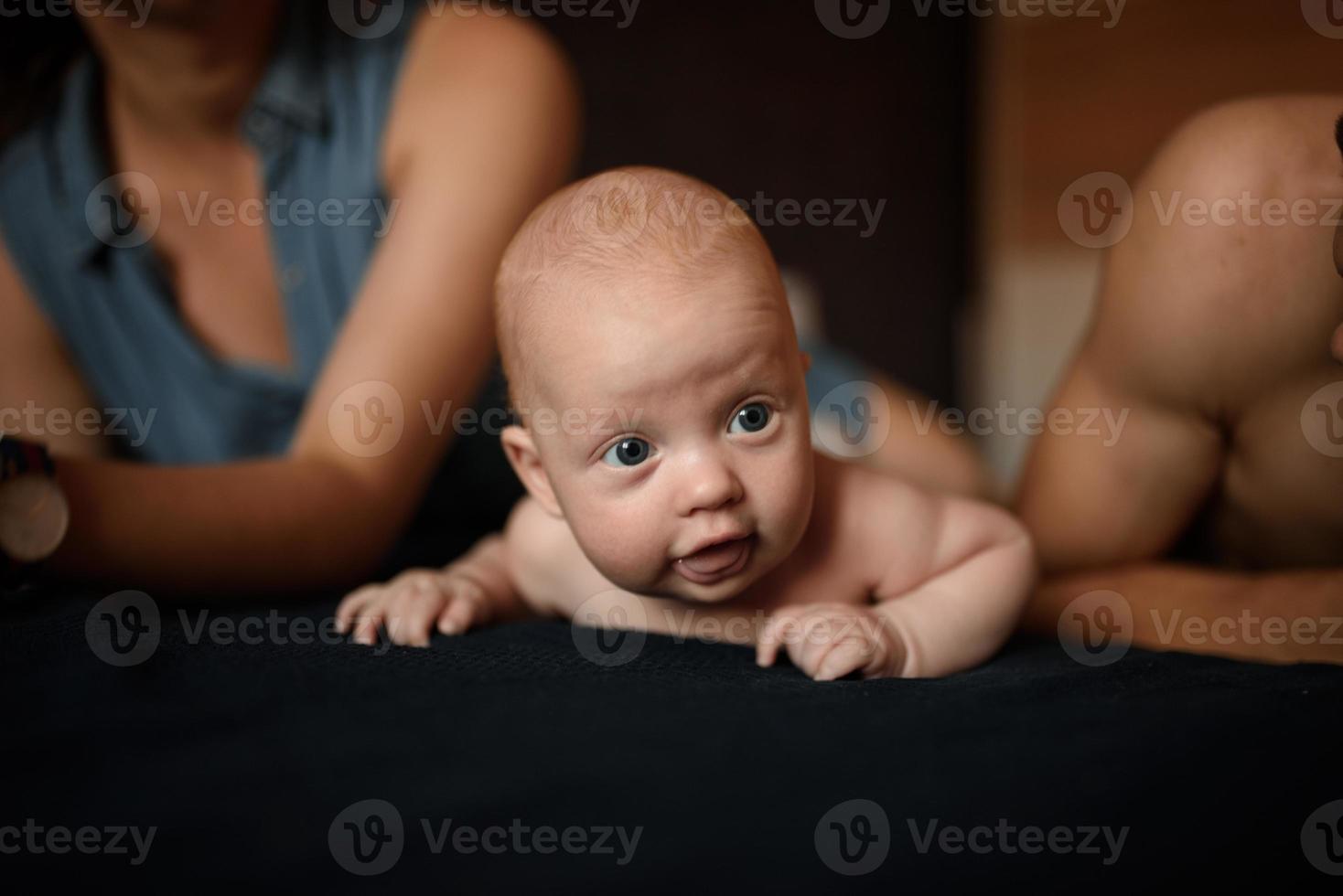 Young parents have fun with their little son photo
