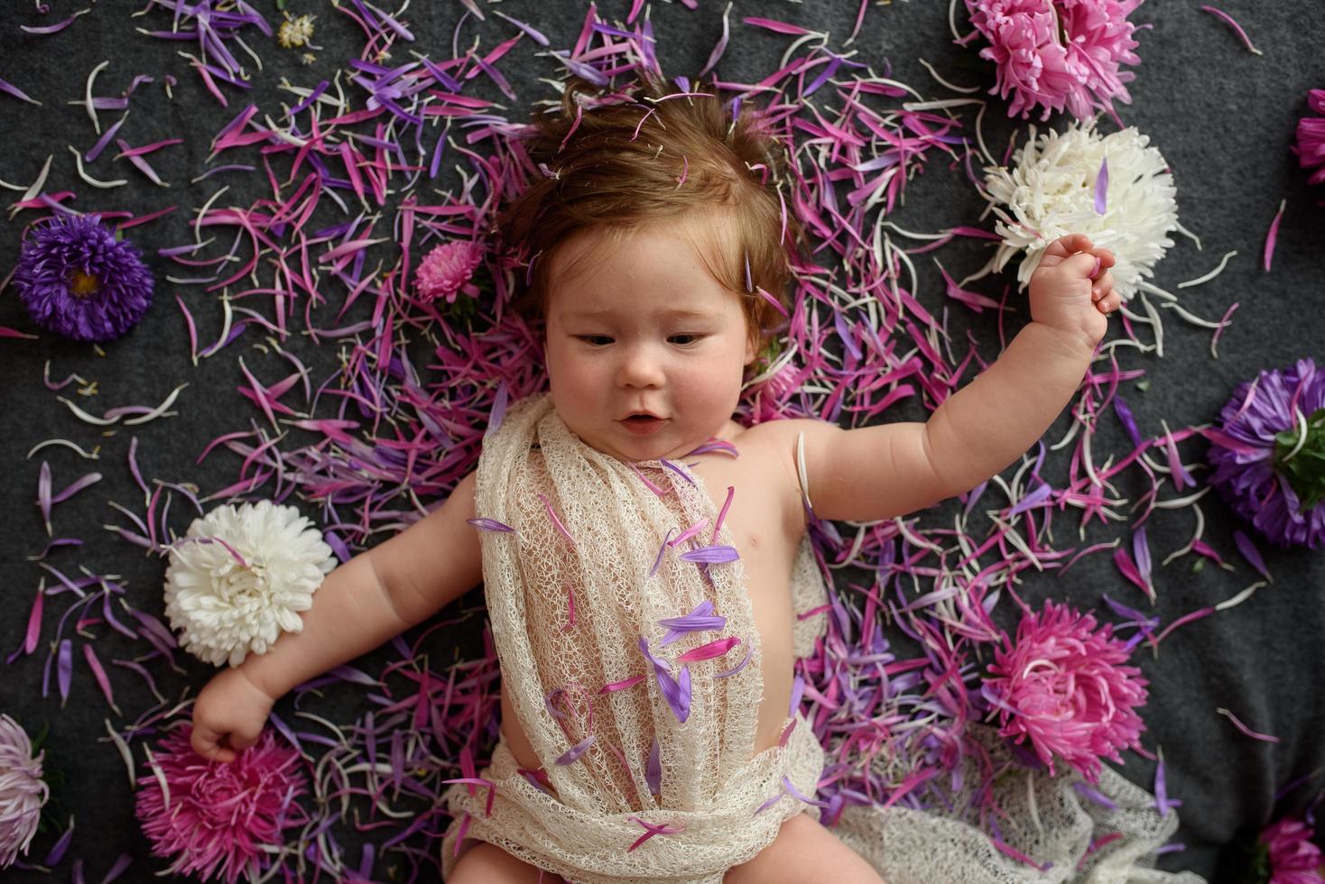 Portrait of little baby girl in white vintage home with flowers photo