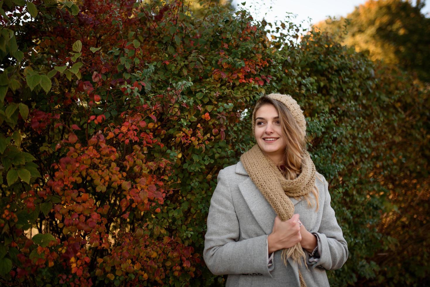 Portrait of a beautiful autumn woman. Girl posing to the camera. photo