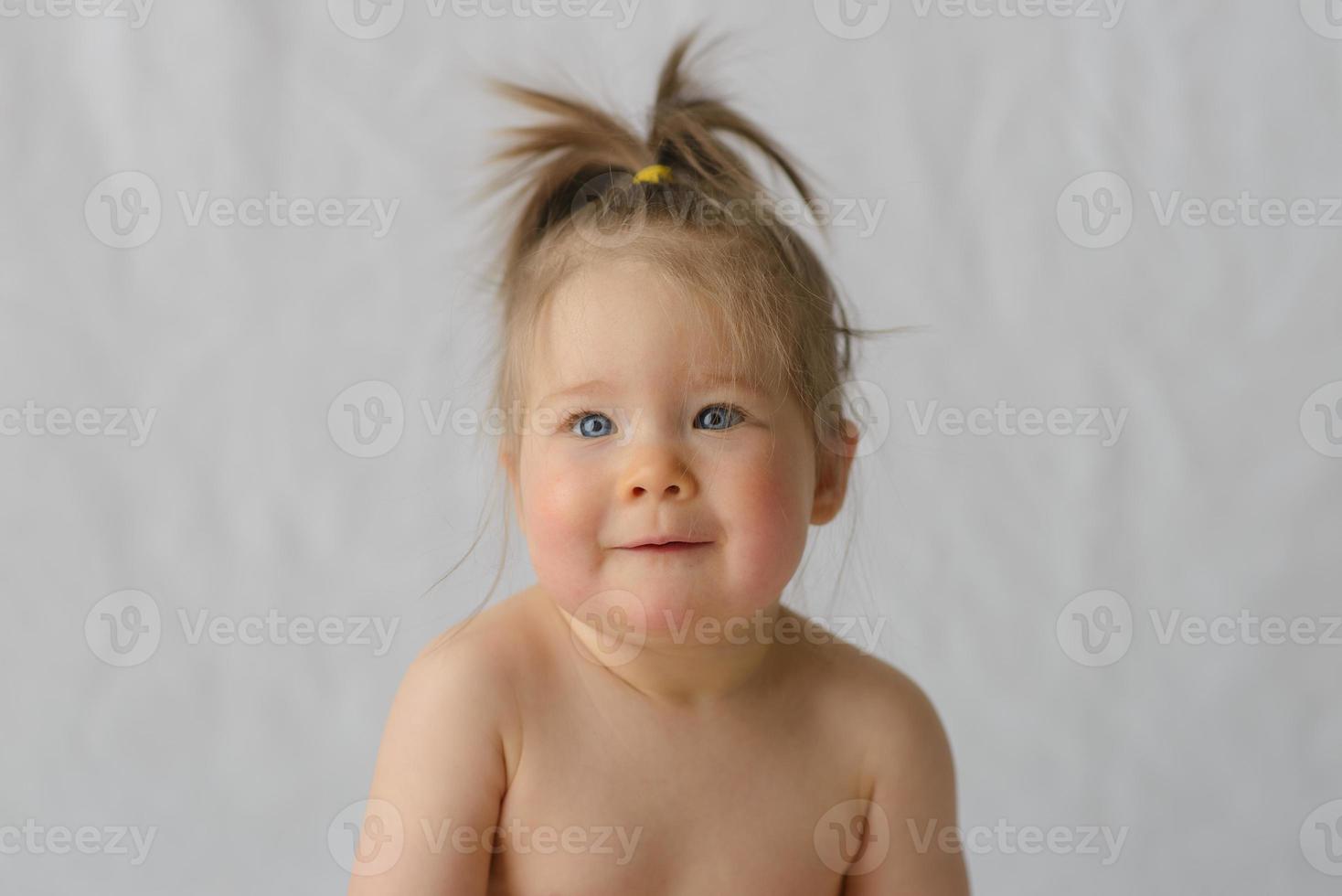 Portrait of a little girl on a white background. photo