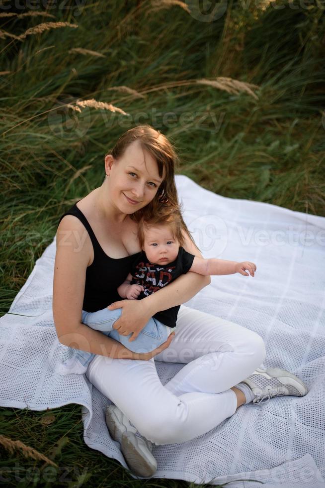 Mom and baby cuddle on a plaid photo