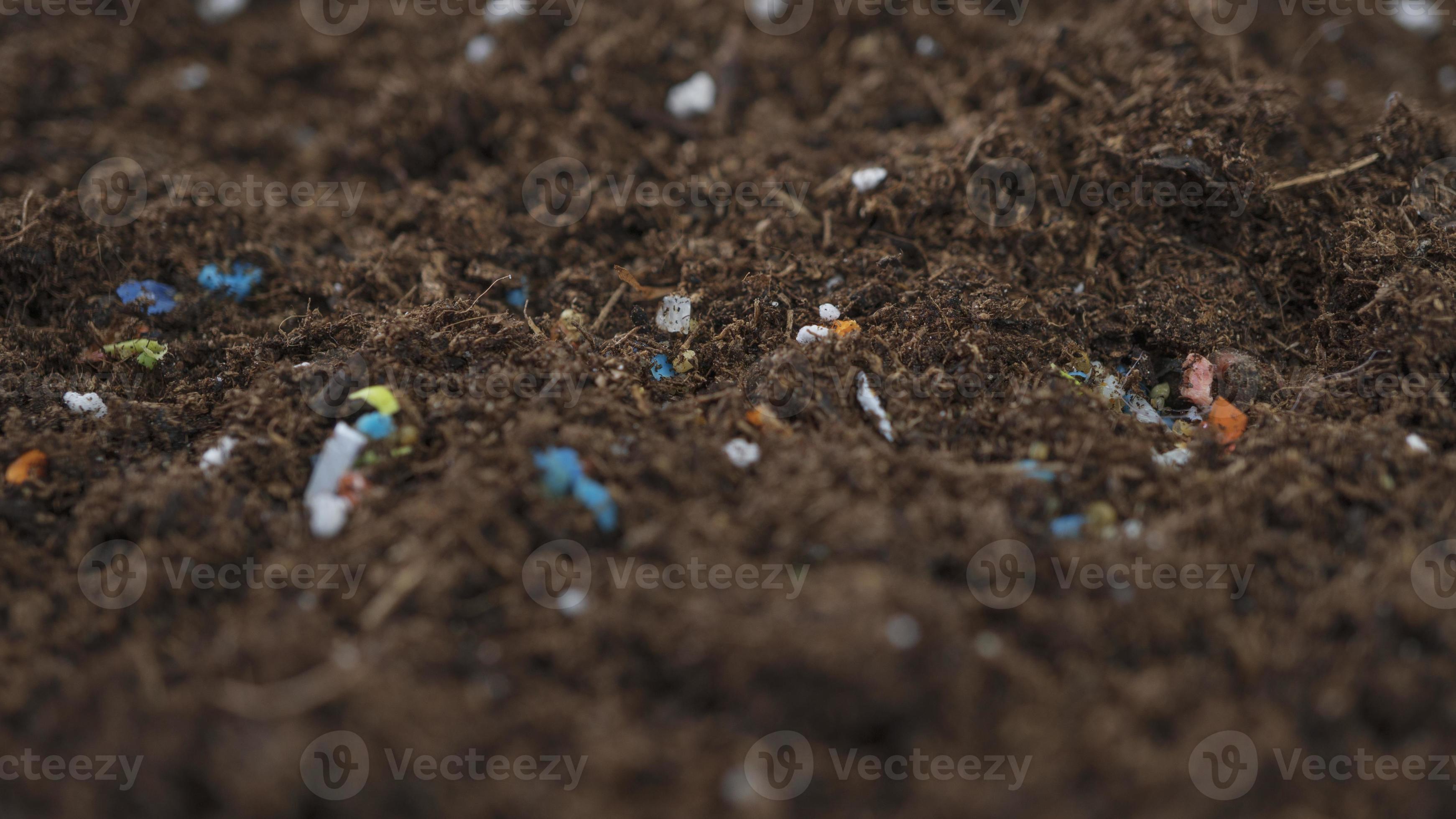 Nonrecyclable plastic pollution in the soil. 6769549 Stock Photo at