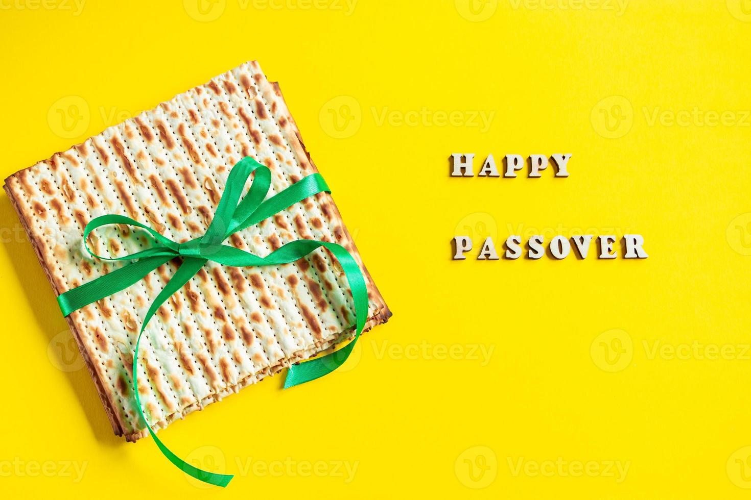 Celebrating the traditional Jewish holiday of Passover. Matzo on a yellow background. Pesach matzah. photo
