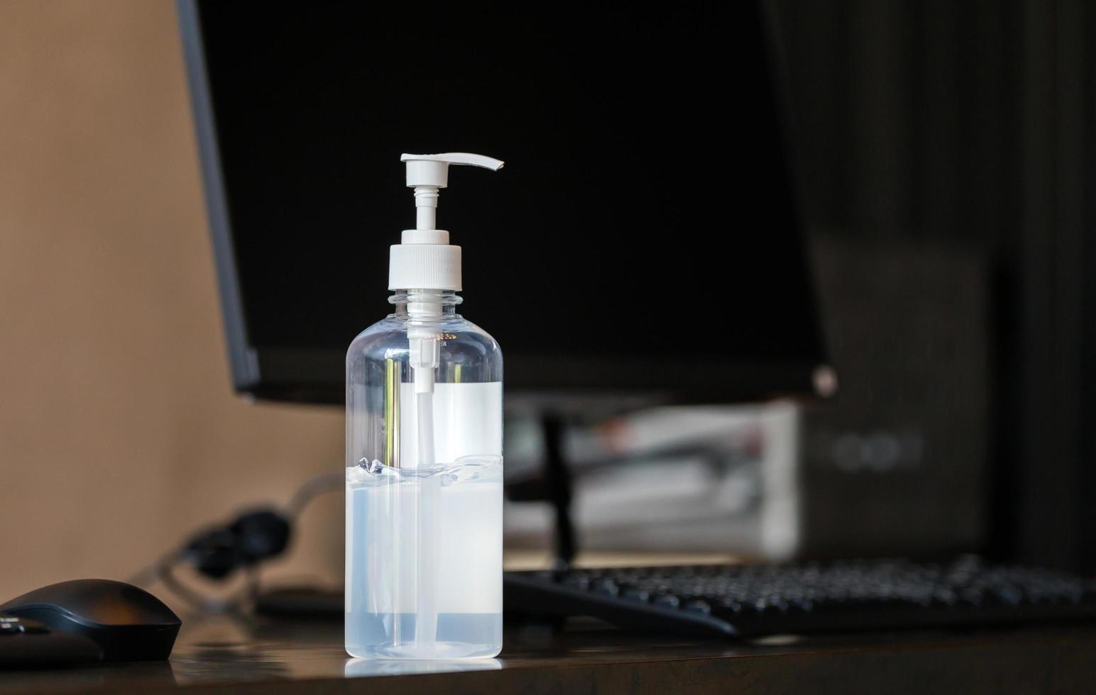 Hand sanitizer alcohol gel pump bottle on the table in office, Health care and COVID-19 Coronavirus concept photo