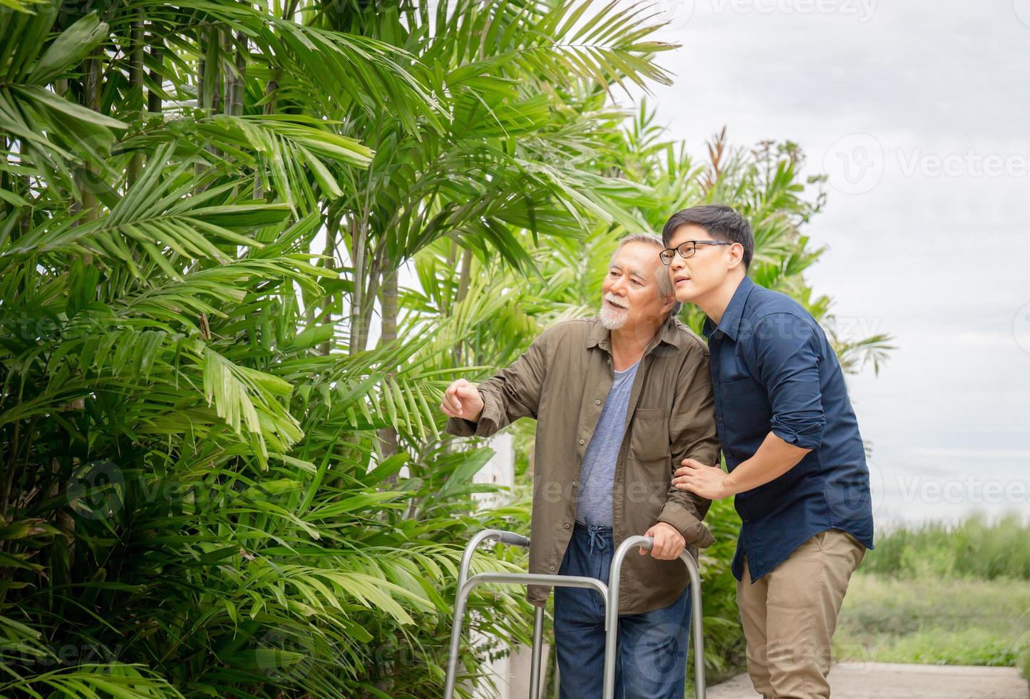 Senior asian father and middle aged son walk in the park, Happiness Asian family concepts photo