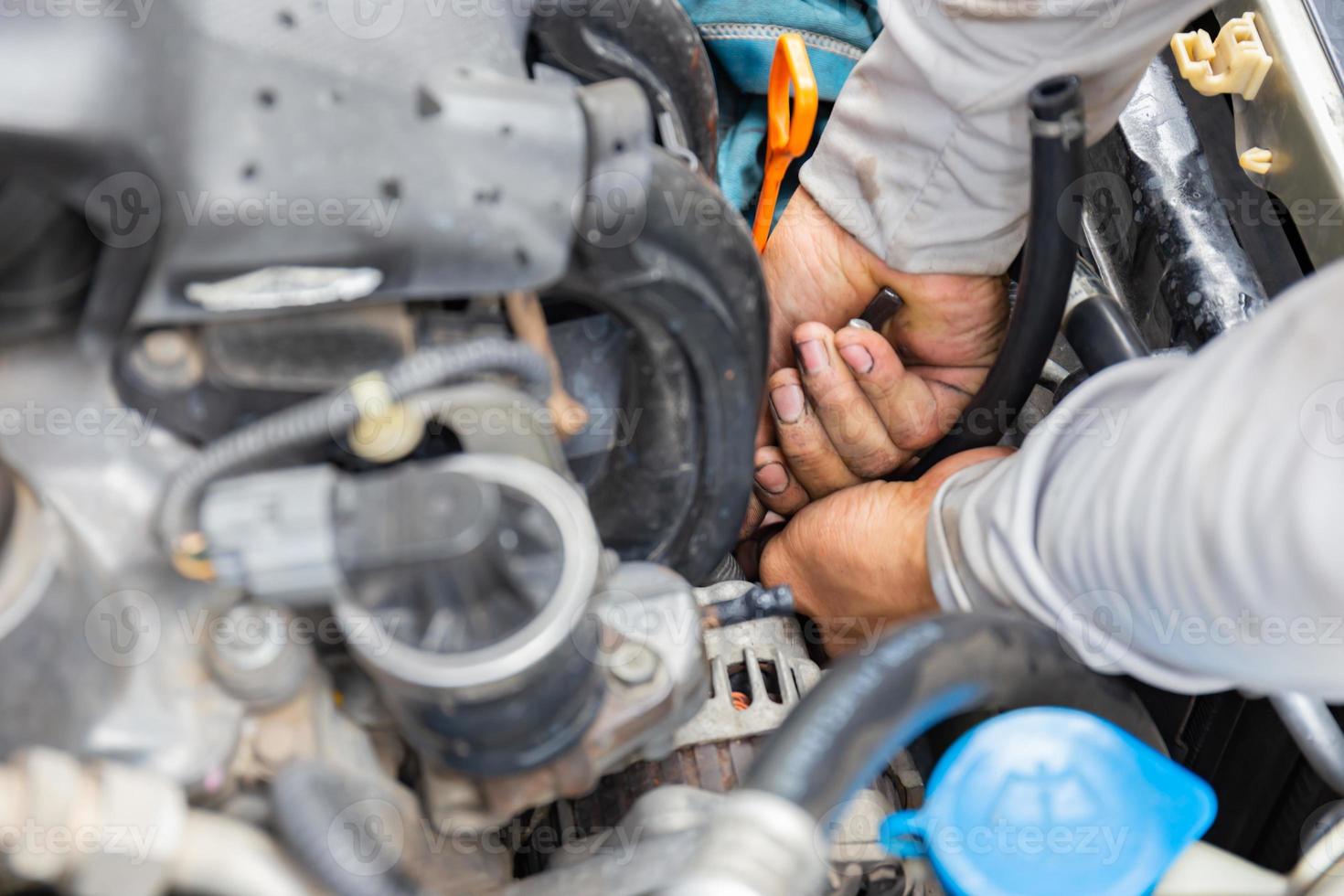 Mechanic fixing hose clamp with pliers tool cooling water pipe at car engine, Car repair concept photo