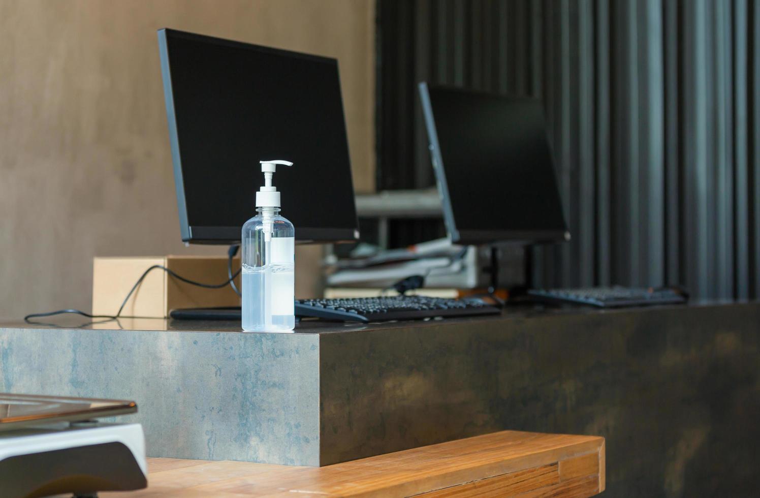 Hand sanitizer alcohol gel pump bottle on the table in office, Health care and COVID-19 Coronavirus concept photo