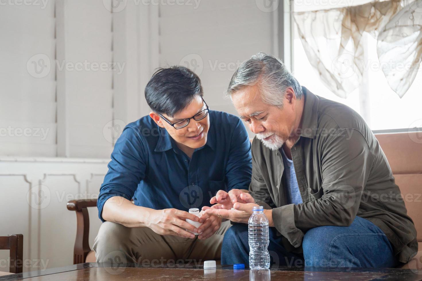 el hijo de mediana edad se ocupa del padre mayor enfermo, los conceptos familiares asiáticos de felicidad foto