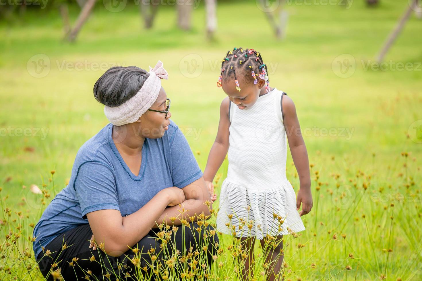 Portrait of african american mother and girl playing together outdoor photo