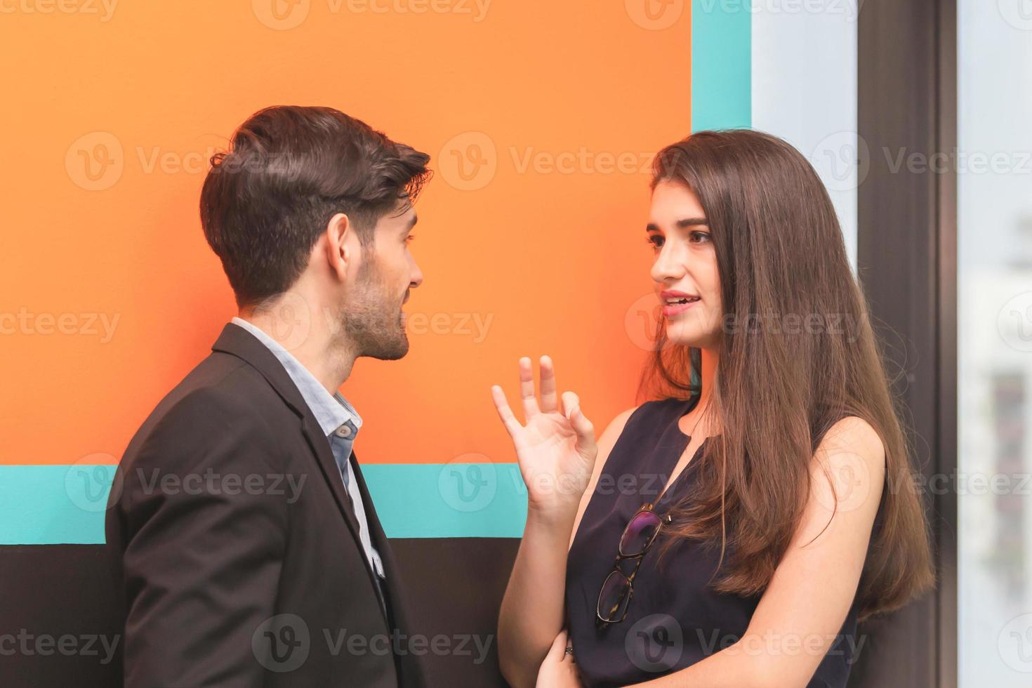 Business woman and businessman talking together other in office, Business team taking a break and relaxing photo