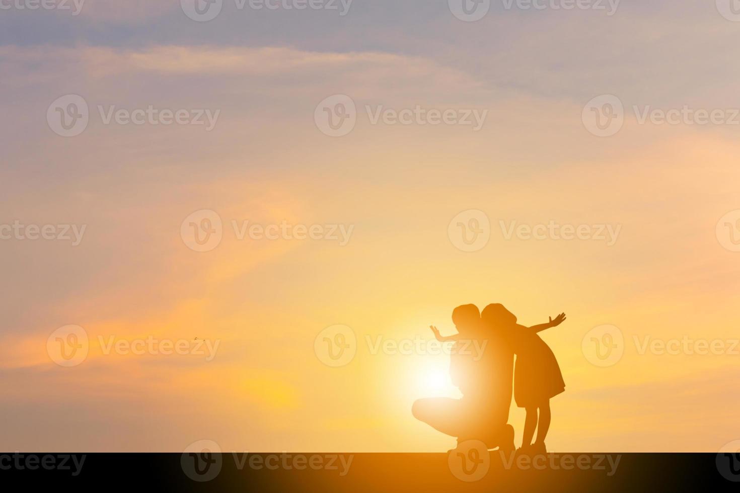 Silhouettes of Happy father and daughter playing at sunset evening sky background. photo