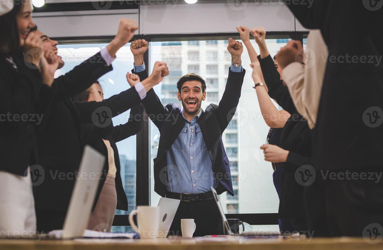 Successful team of young perspective business people in office, business group celebrating after meeting, Success and teamwork concept photo