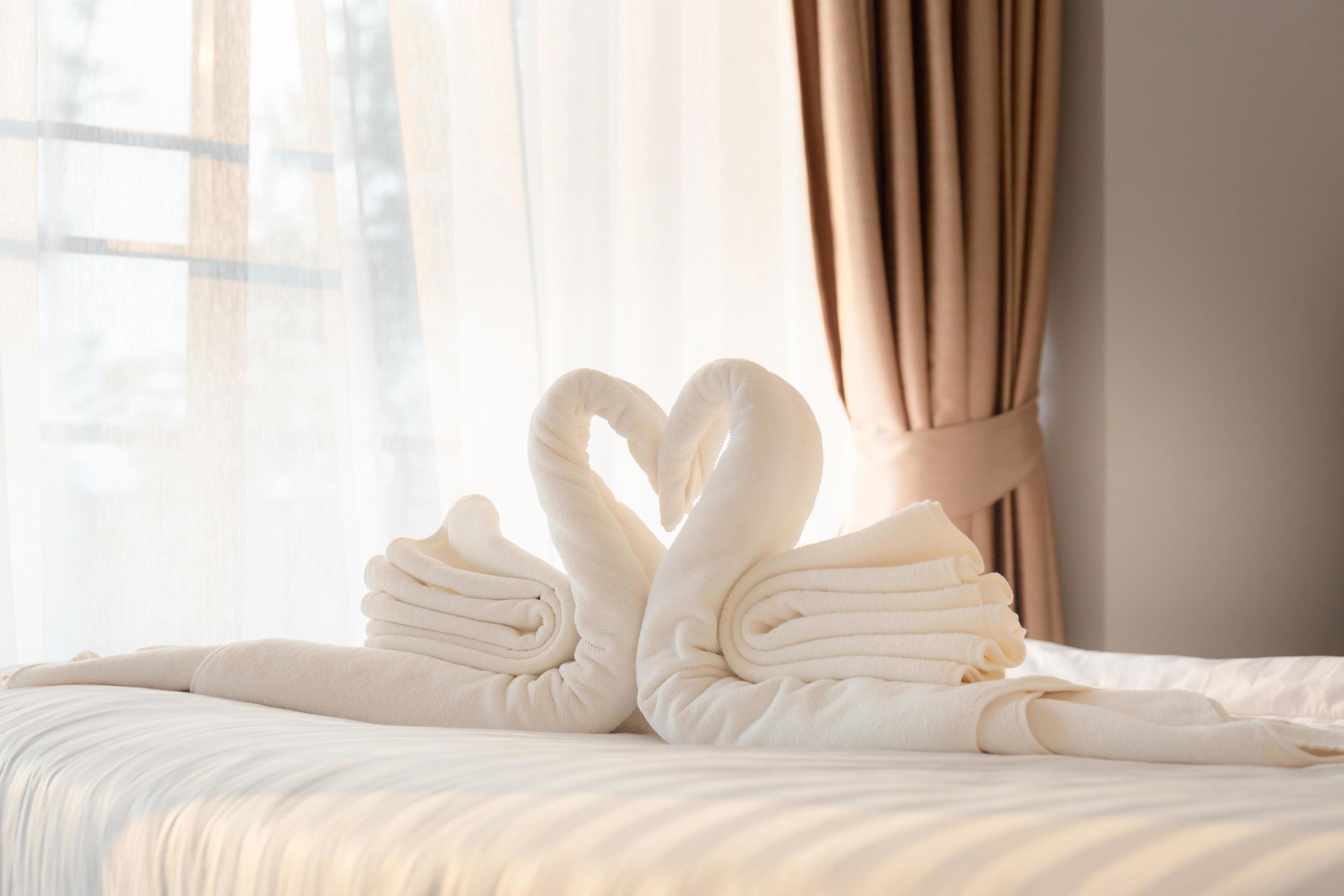 Towel folded in swan shape on bed sheet in bed room 6774460 Stock Photo
