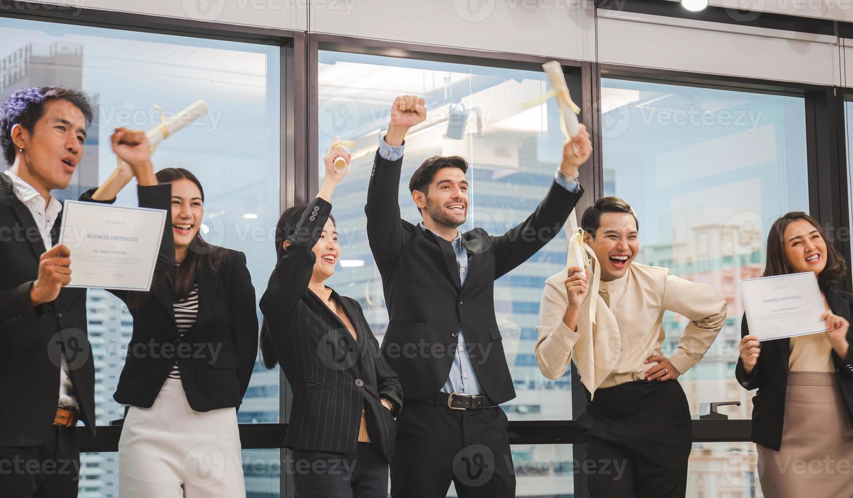 Successful team of young perspective business people in office, Success business group celebrating after meeting holding fake certificate photo